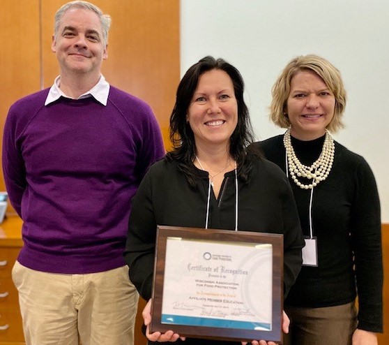 Adam Borger, Erika Bognar and Kara Baldus showing off the Education Affiliate award, which was awarded in July at the annual meeting. Education Committee members not in attendance were Kim Destromp and Gina Mode.